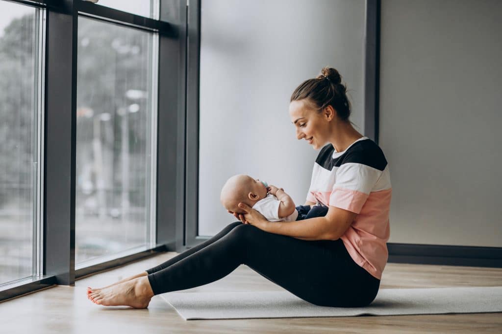 Woman with baby boy practice yoga mama-baby yoga